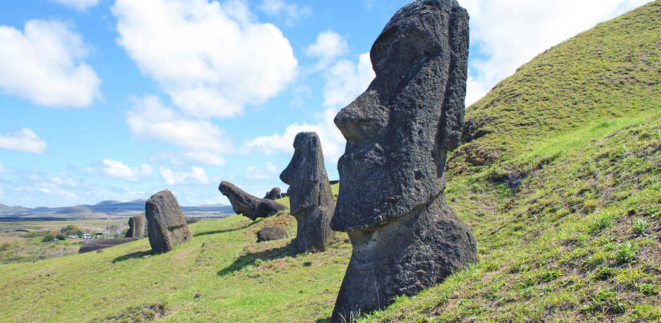 Moai statutes on a green hillside on Easter Island