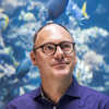 Portrait of Steinhart Aquarium director Bart Shepherd in front of Philippine Coral Reef exhibit