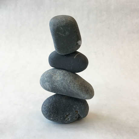 a cairn of four rocks on top on one another