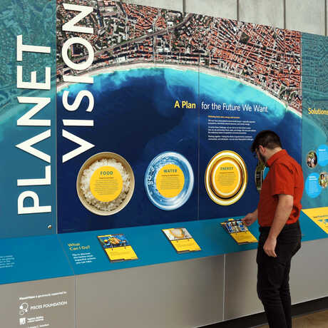 A guest looks at the new PlanetVision exhibit at the California Academy of Sciences