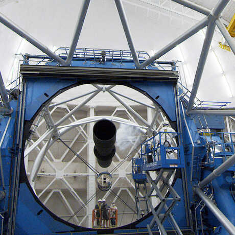 Technicians cleaning the 4-meter mirror inside Chilean telescope