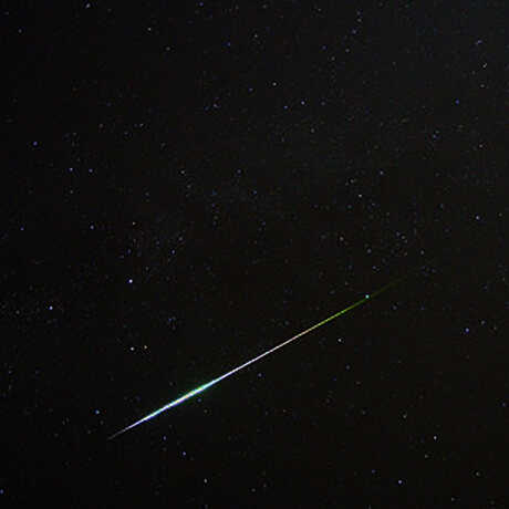 Perseid meteor streaking across night sky