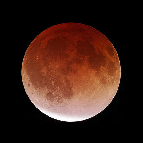 Reddish moon during a partial lunar eclipse