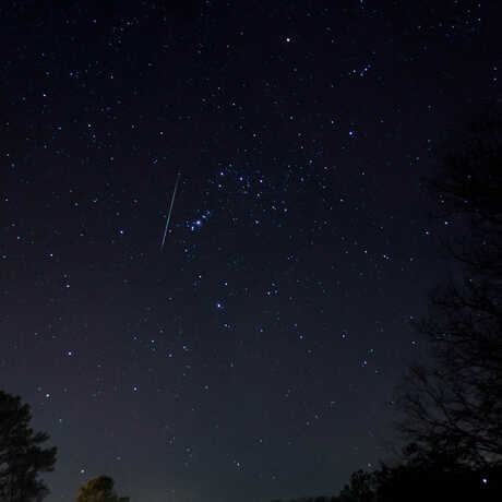 Geminid meteor shower in night sky