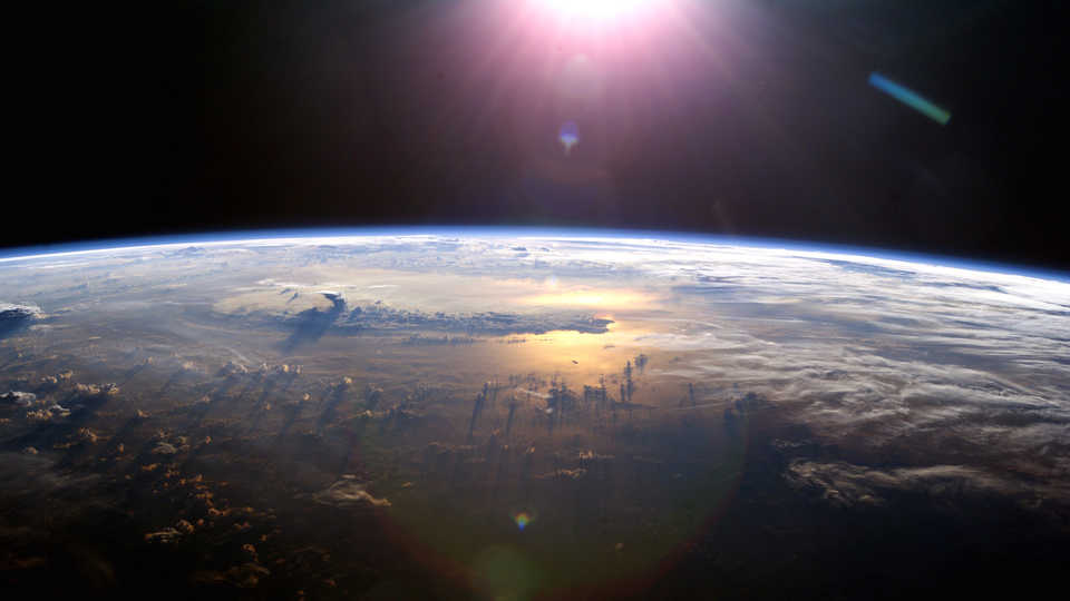 Sun over Earth from the ISS, 2013; NASA