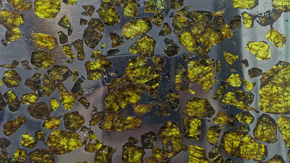Fukang meteorite slice, pallasite. Exhibit at the Center for Meteorite Studies, Arizona State University, Tempe, Arizona, USA