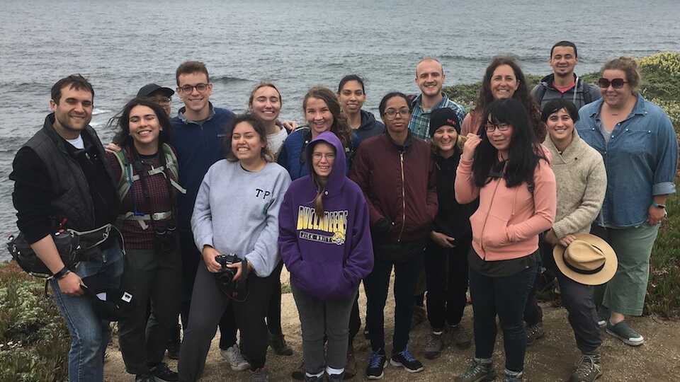 Students and instructors on a cliff overlooking the Pacific Ocean