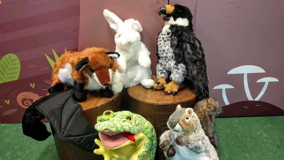 A group of animal puppets including a squirrel, frog, rabbit, falcon, and fox.